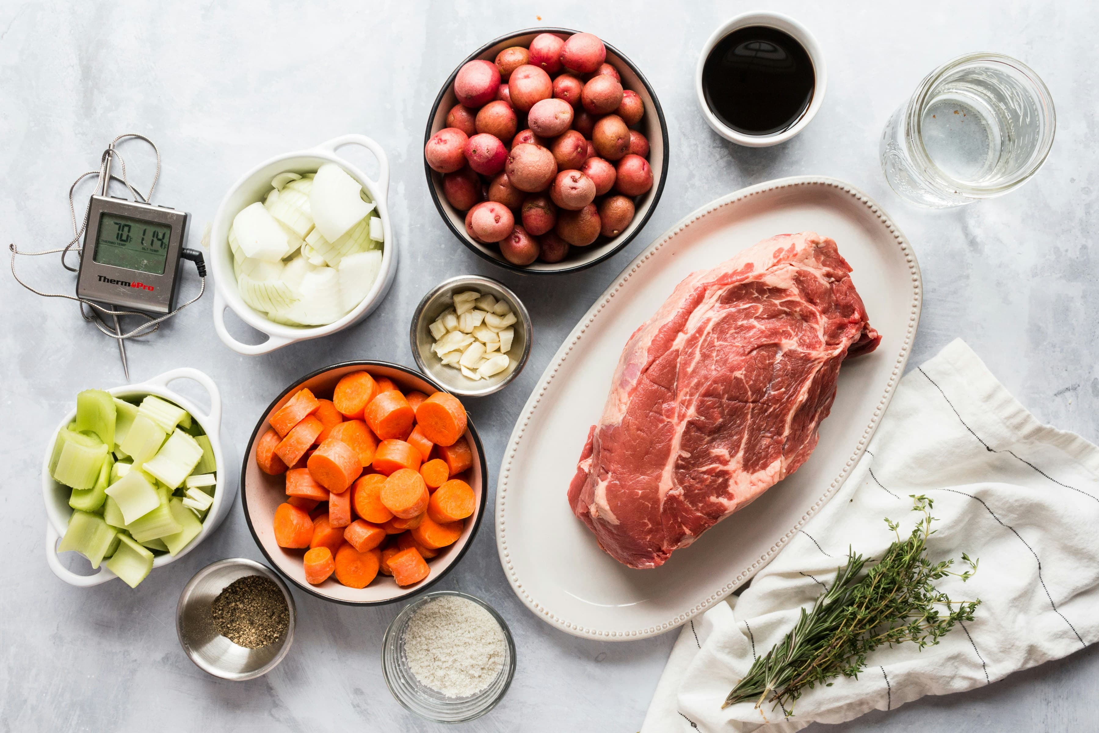 A variety of vegetables and fresh ingredients on a cutting board.